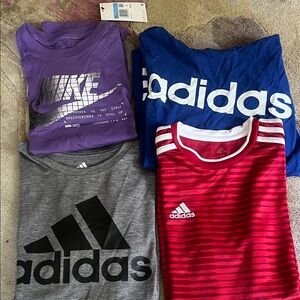 Four boys shirts.. Three Adidas and one Nike. Size Medium (10-12)